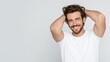 © Newleks - Happy young man smiling, showing healthy hair, touching head, looking at camera, feeling good about personal grooming and attractive appearance, positive male portrait