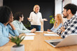© Maria Vitkovska - Smiling successful businesswoman leading team meeting in modern office, planning project