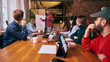 © master1305 - Business team listening to presentation in modern coworking space. Concept of leadership communication, shared goals, professional growth and collaborative office environment.