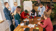 © master1305 - Coworkers reviewing project results during office meeting. Concept of business evaluation, teamwork communication, collaborative analysis and corporate performance.