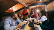 © master1305 - Creative professionals collaborating during startup meeting indoors. Concept of teamwork, business communication, innovation process, and modern office collaboration.