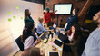 © master1305 - Coworking team reviewing ideas on screen in modern workspace. Concept of project presentation, team alignment, visual collaboration in office environment.