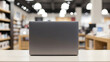 © StockClarity - Laptop on a table in a store with shelves and lights computer