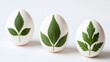 © Natalya - three white easter eggs with green leaves pressed against shells prepared for natural dyeing, for diy craft tutorials, spring blogs, organic lifestyle sites, and holiday cards, with copy space