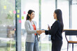 © David - Happy business asian manager handshaking client at meeting. Smiling female hr hiring recruit at job interview, insurance agent, lawyer making contract deal at work with business handshake.