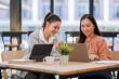© David - Business  asian women two people discussing the data and making decisions based on laptop the information presented