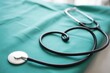 © MdSahab - Professional black stethoscope lying on a clean green medical surgical drape in a hospital setting