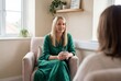 © Meow Creations - Blonde female therapist listening to a client during a private counseling session in a cozy office