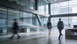 © Art_spiral - a modern office lobby scene with blurry figures walking through a large glass and steel structure conveying a sense of