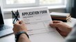 © lianlian liang - Close up of hands holding application form document at office desk with blurred laptop background, symbolizing job hiring, bank loan approval, university admission, visa processing, or insurance claim