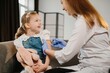 © dsheremeta - Smiling child receiving vaccination from medical professional for health