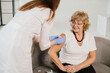 © dsheremeta - Nurse vaccinating senior woman protecting a vulnerable population