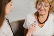 © dsheremeta - Healthcare worker using stethoscope checking senior woman's heart