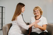 © dsheremeta - Doctor checking smiling senior woman's heart with stethoscope