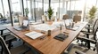 © Kusal Sirimanna - Low angle view of modern open-plan office conference table with laptops, notebooks, coffee mugs and natural light
