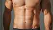 © A2Z AI  - A muscular man's torso with defined abs and arms is showcased in a neutral setting. The lighting highlights the contours of the body, creating a visual statement of health & fitness.