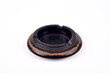 © zdravinjo - Handcrafted vintage black wooden carved ashtray isolated on the white background. Selective focus.