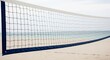© Jafree - Close up of a beach volleyball net with sandy beach and ocean in the background, a concept of summer vacation and beach sport.