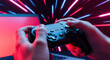 © abu - Close up of hands holding a black game controller against a red and blue neon background with laptop, ideal for gaming content.