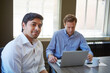 © BuyoutReese05/peopleimages.com - Businessman, smile and team at office meeting for review, portrait or collaboration at insurance company. Person, broker and laptop with pride, career or happy for project at risk assessment agency