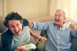 © peopleimages.com - Man, senior father and video game on couch with controller, laugh and digital challenge in lounge. Elderly person, adult son and push for virtual contest, competition or happy on sofa at family house