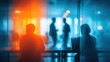 © AnnovaGraphics - Business people working in modern office with colorful lighting and blurred background