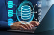 © tadamichi - Data warehouse. Integrated database for business data analysis. Businessman leveraging business intelligence on laptop computer.