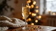 © you - dcf. A champagne flute with golden bubbles on a wooden table beside a cozy blanket and festive confetti. bar promotions, beverage menus, designed for food & beverage menus and cafe branding.