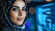 © Yuliia - Young Middle Eastern woman wearing elegant black hijab with sparkling details in modern tech environment with blue digital lighting and bokeh effects.