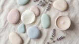 Calming pastel stones and lavender sprigs arranged on a textured fabric for spa relaxation