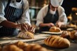 © Iftikhar alam - Students engage in collaborative baking activities in a culinary class focused on bread-making skills and techniques at a local cooking school during the late afternoon session