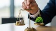 © su - Investor hand holding scale balancing coins and green tree for ethical investment and impact portfolio management