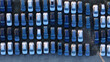 © Antonia - Rows of new cars parked in a large outdoor distribution lot, view from above showing automotive mass production and transportation logistics