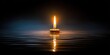 © RaadCreative - Lit Candle Flame Reflecting in Water with Dark Background Showing Warm Yellow Light and Blue Tones