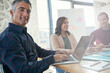 © BuyoutReese05/peopleimages.com - Laptop, portrait and meeting with business man in office for about us, confidence and upskill workshop. Pride, training session and team with employee for opportunity, coworking and tech development