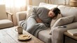 © mr_marcom - Woman experiencing abdominal pain or morning sickness on a cozy couch