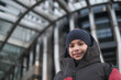 © Antonio Recena - Ten Year Old Caucasian Boy Smiling at Camera Wearing Winter Hat with Building in the City