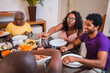 © Nexa - Happy multi-generational family sharing a meal together at home sitting around a dining table.
