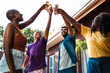 © Nexa - Diverse group of happy friends and family cheering with beer glasses during an outdoor backyard celebration.