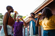 © Nexa - A diverse group of happy friends and family drink beer together at an outdoor backyard party.