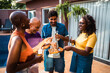© Nexa - Happy diverse group of friends and family enjoying a social gathering with beer and snacks by a swimming pool on a sunny day.