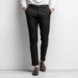 © Ngamsiri - A stylish man poses in formal black trousers, showcasing the tailored fit and elegant design complemented by brown leather shoes against a simple backdrop.
