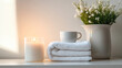 © Al-Mamun - Self-care concept with candle, soft towel, and ceramic cup