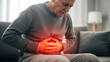 © Barca - Elderly man suffering from severe stomach pain, clutching his abdomen.