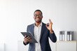 © Prostock-studio - Portrait of cheerful black male psychologist showing okay gesture, recommending professional help at clinic. Confident young African American psychotherapist smiling at camera in office