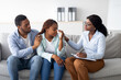 © Prostock-studio - Millennial black woman crying at psychologist's office, loving husband supporting her with professional counsellor. Young lady with her spouse trying to solve problem with psychologist