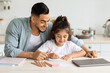 © Prostock-studio - Happy middle-eastern single father and little daughter painting together, kitchen interior, copy space. Young arab man dad spending time with his beautiful kid, doing art and craft at home