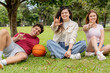 © Jordan - Friends on grass making the I Love You sign language gesture