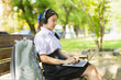 © Quality Stock Arts - Asian student teen cute girl using laptop online learning education wireless outdoor green park
