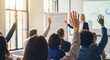 © Yana - Diverse audience raising hands during business seminar